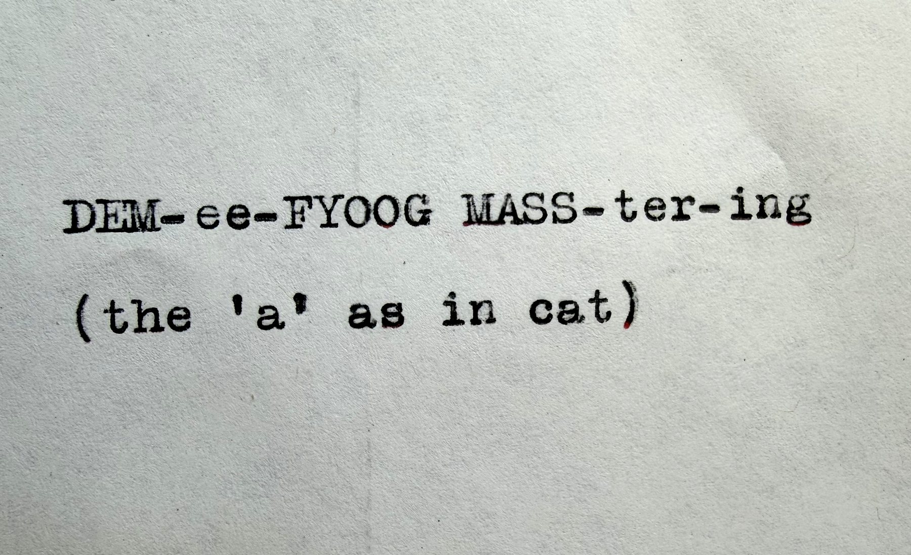 Typewritten pronunciation guide: DEM-ee-FYOOG MASS-ter-ing (the 'a' as in cat)